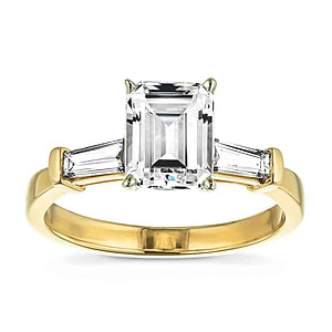 three stone baguette ring with an emerald cut lab grown diamond center stone