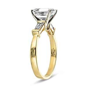 three stone baguette ring with an emerald cut lab grown diamond center stone