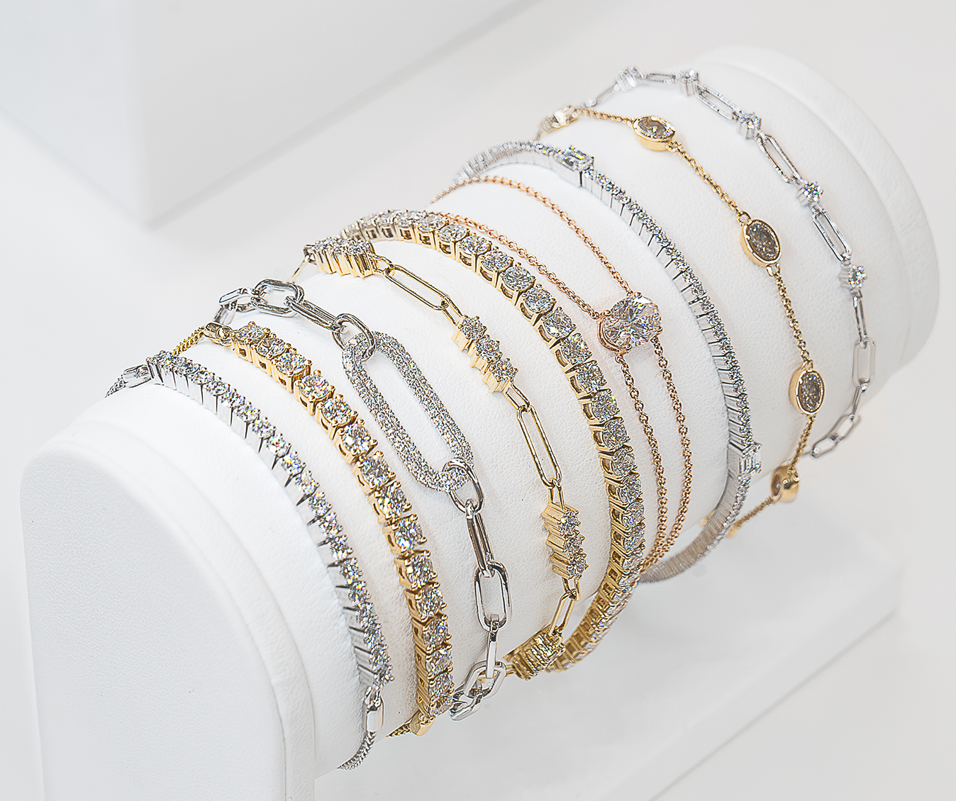 Set of gold and silver bracelets on a white surface