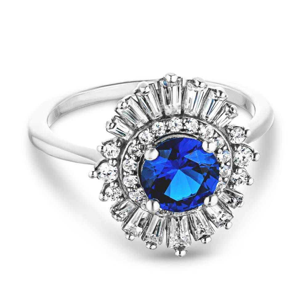 Shown with 1ct Round Cut Lab Grown Blue Sapphire|Unique stunning vintage style diamond halo engagement ring with baguette cut diamonds surrounding a 1ct round cut lab grown blue sapphire in 14k white gold