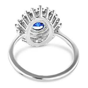 Vintage style diamond halo engagement ring with baguette cut diamonds surrounding a 1ct round cut lab grown blue sapphire in 14k white gold shown from back