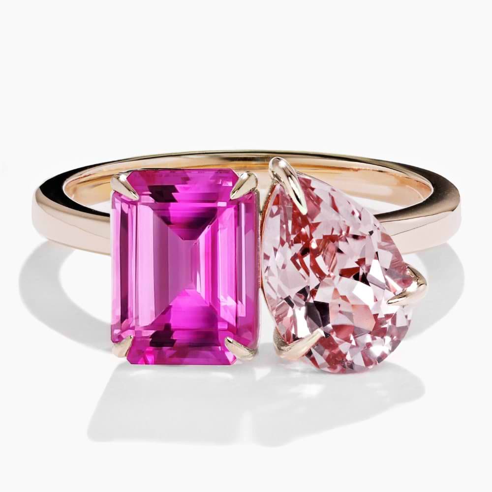 Shown in 14K Yellow Gold with an Emerald Cut Lab Created Pink Sapphire and a Pear Cut Lab Created Pink Champagne Sapphire|toi et moi two stone engagement ring wth emerald cut and pear cut sapphires lab grown gemstones set in 14k yellow gold recycled metal by MiaDonna