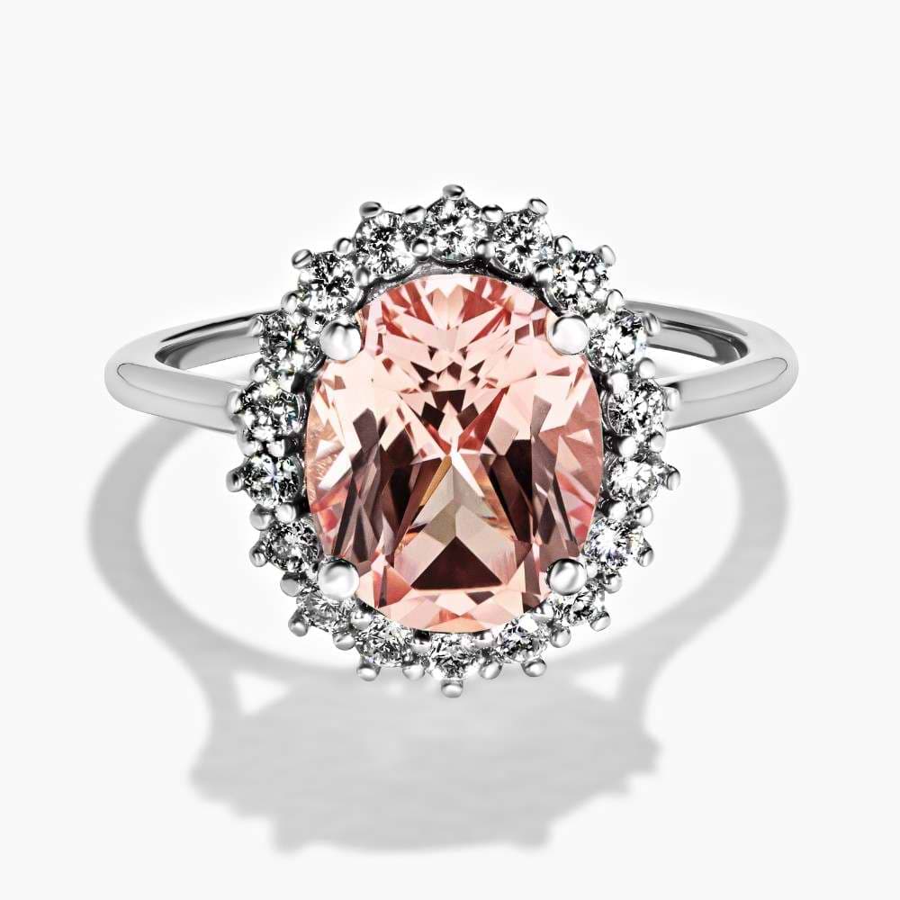 Shown here in 14K White Gold with an Oval Cut Pink Champagne Sapphire|halo engagement ring with a lab grown gemstone oval cut center stone with a lab grown diamond accented halo by MiaDonna