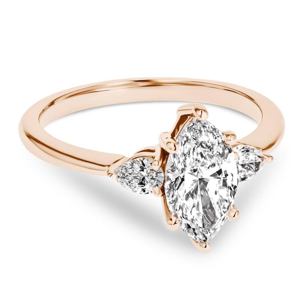 Shown In 14K Rose Gold With A Marquise Cut Center Stone|three stone ring with accenting pear cut stone and a marquise cut lab grown diamond center stone