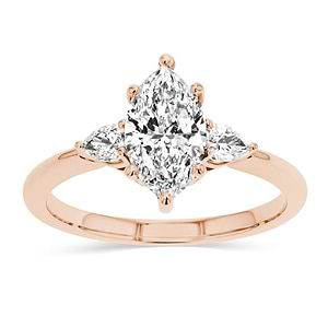 three stone ring with accenting pear cut stone and a marquise cut lab grown diamond center stone