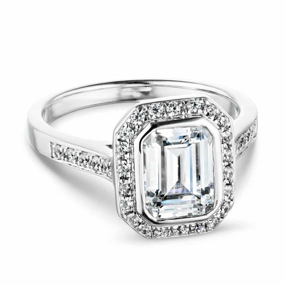 Shown with 1ct Emerald Cut Lab Grown Diamond in 14k White Gold|Antique style diamond accented halo engagement ring inspired by tiffany co legacy ring