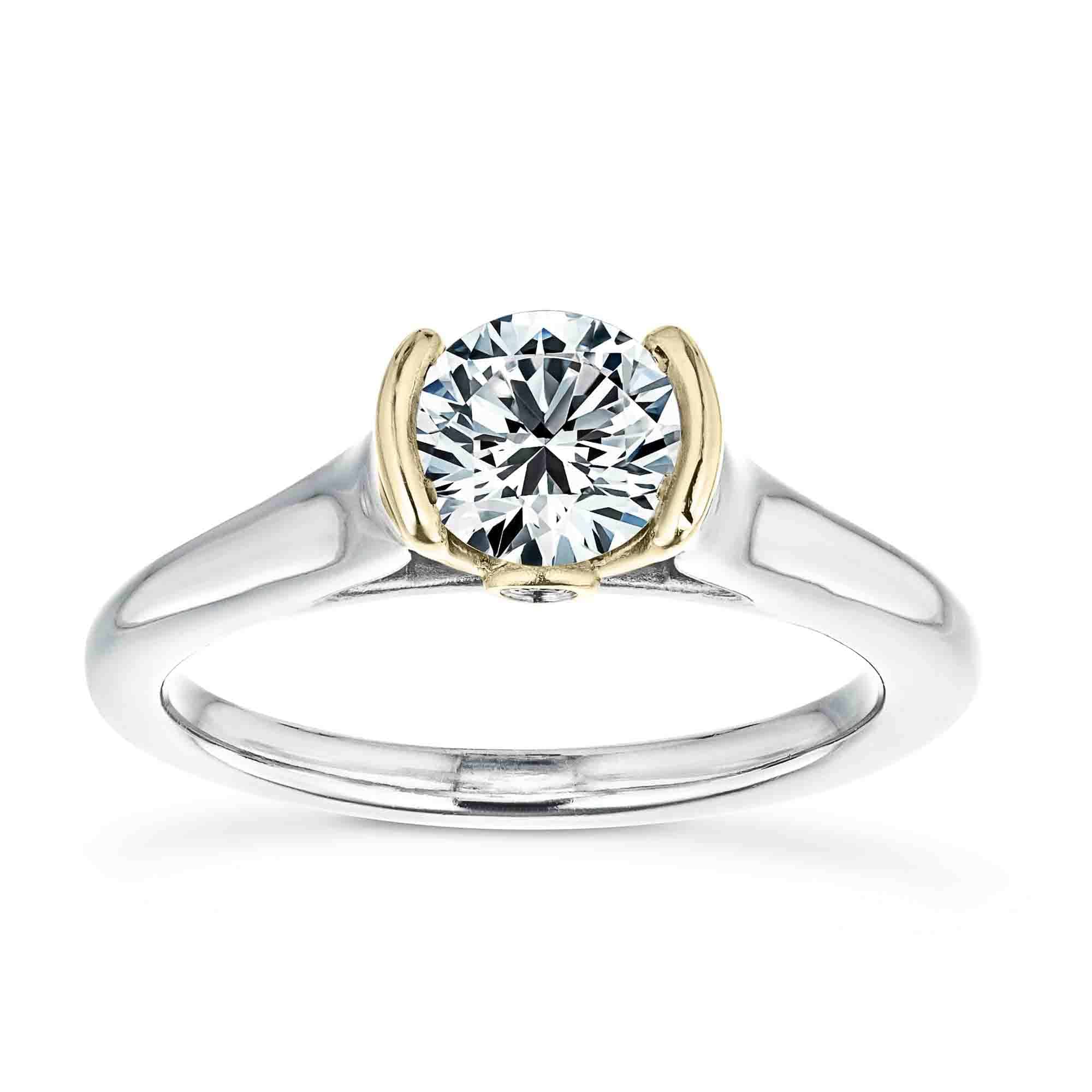Shown with 1ct Round Cut Lab Grown Diamond in 14k White Gold and 14K Yellow Gold|Unique modern solitaire two tone engagement ring with half bezel set 1ct round cut lab grown diamond above a peek-a-boo diamond in 14k white gold and 14k yellow gold