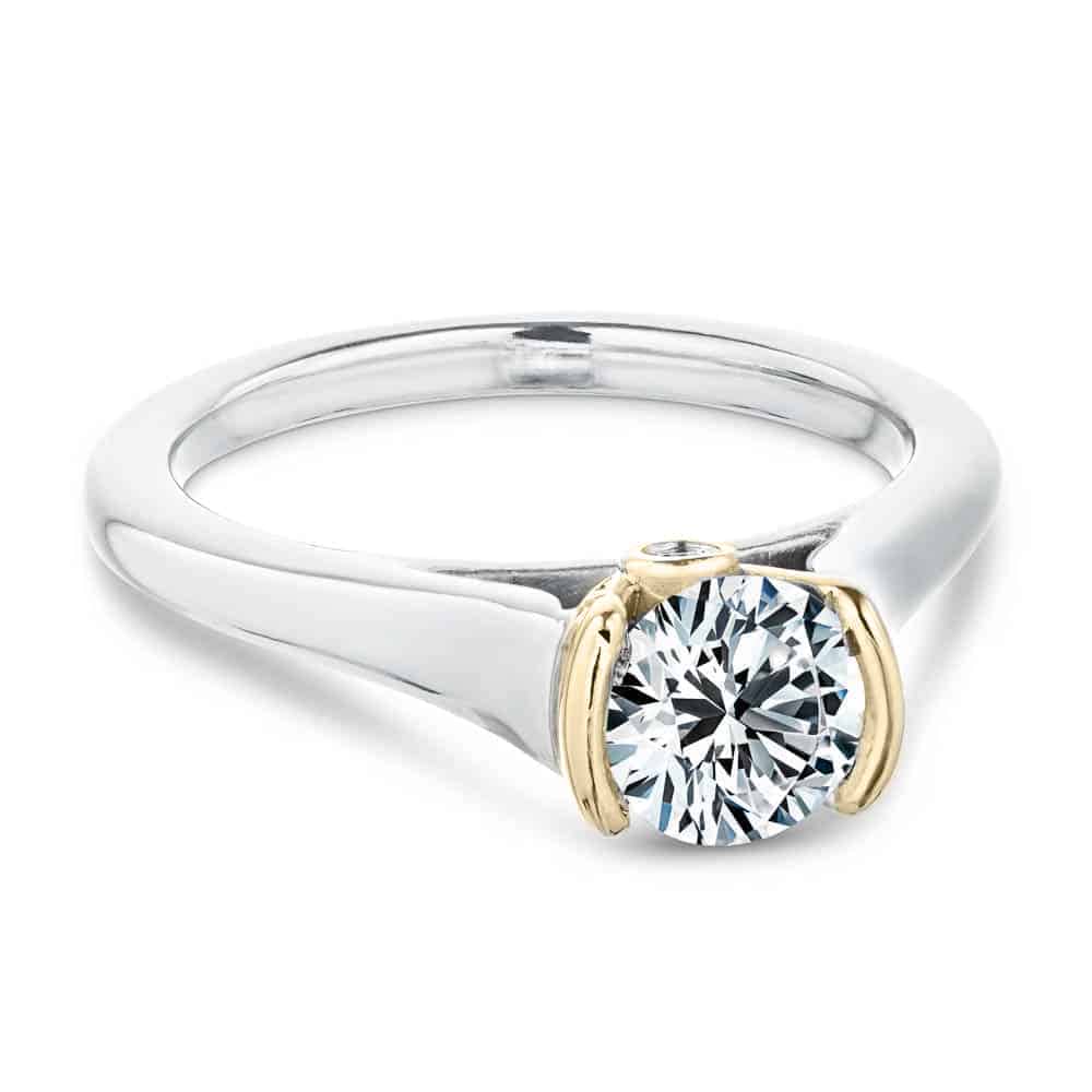 Shown with 1ct Round Cut Lab Grown Diamond in 14k White Gold and 14K Yellow Gold|Unique modern solitaire two tone engagement ring with half bezel set 1ct round cut lab grown diamond above a peek-a-boo diamond in 14k white gold and 14k yellow gold