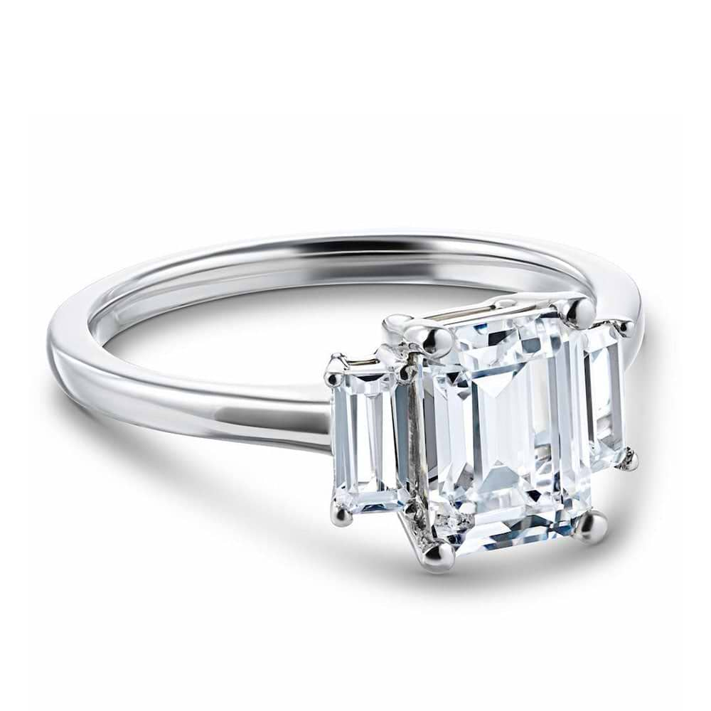 Shown with 1.75ct Emerald Cut Lab Grown Diamond in 14 White Gold|Ethical three stone engagement ring with 1.75ct emerald cut lab grown diamond center stone and two baguette cut diamond side stones in 14k white gold