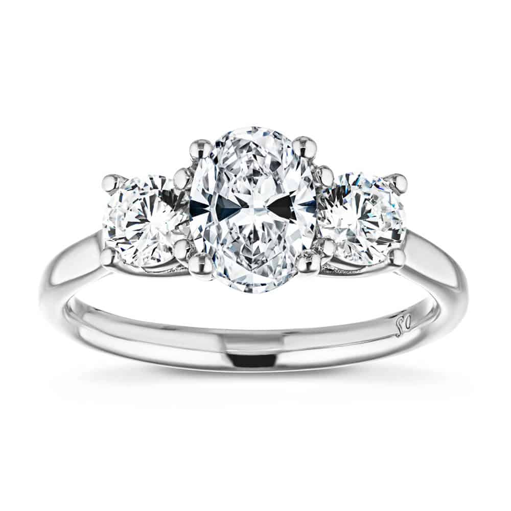 Shown with 1ct Oval Cut and Two 0.5ct Round Cut Lab Grown Diamonds in 14k White Gold|Romantic three stone engagement ring with 1ct oval cut lab grown diamond and two 0.5ct round cut lab diamond side stones in 14k white gold