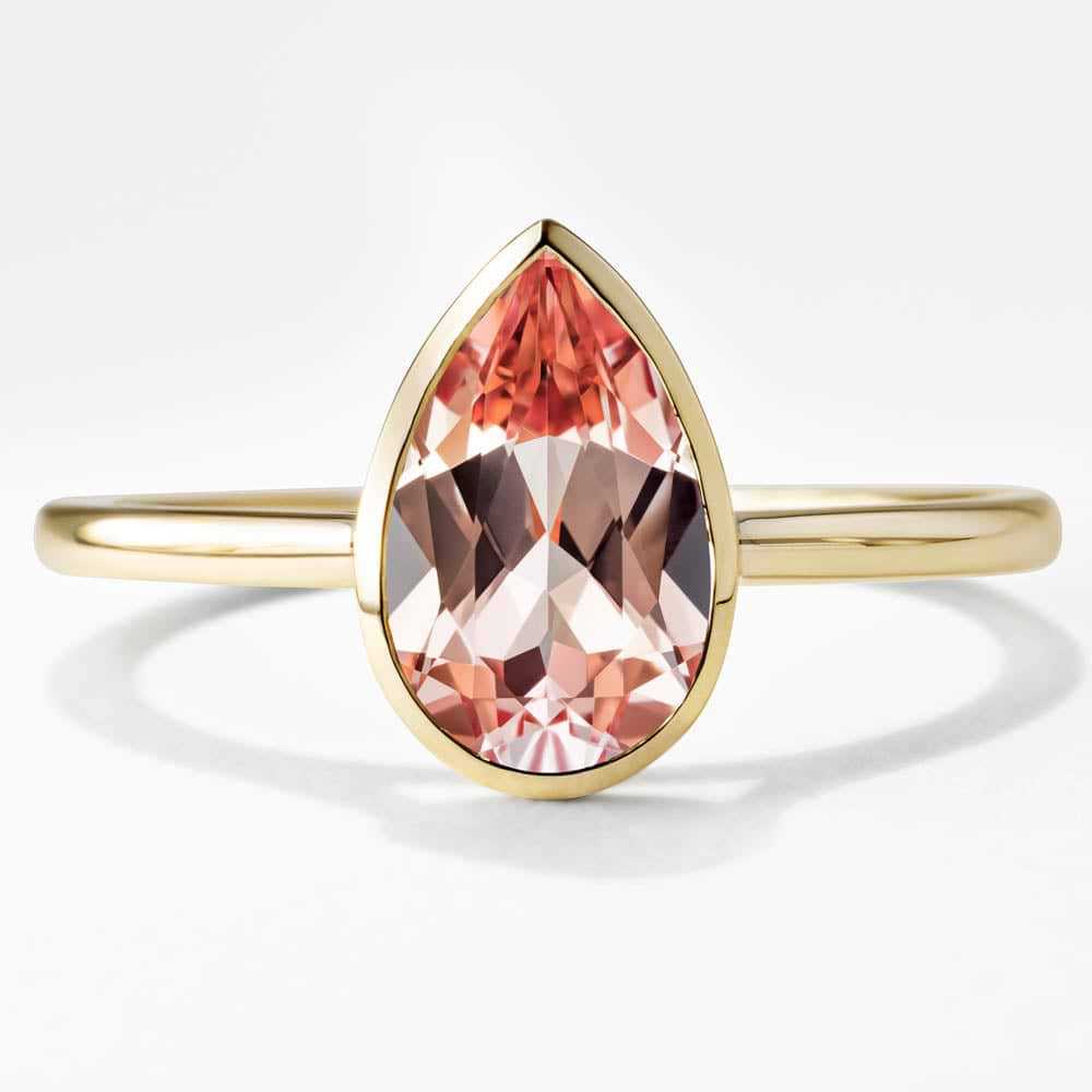 Shown here in 14K Yellow Gold with a Pear Cut Lab Created Pink Champagne Sapphire Center Stone