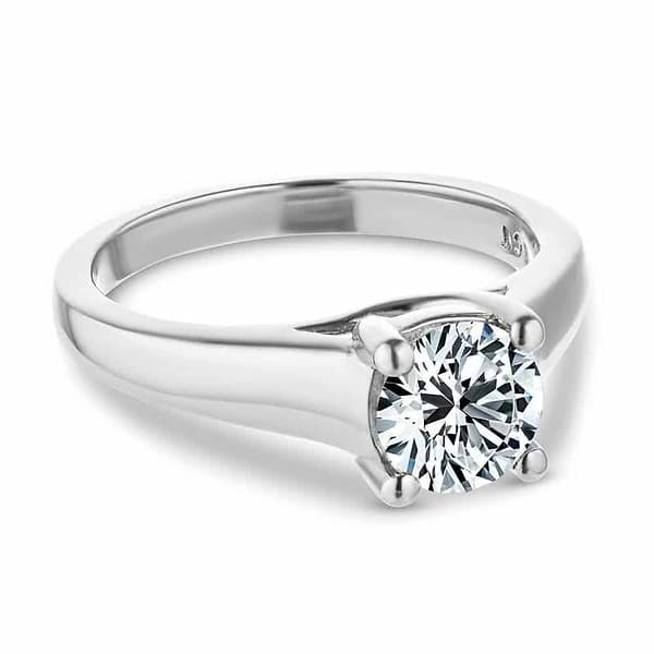 Shown with 1ct Round Cut Lab Grown Diamond in 14k White Gold|Solitaire engagement ring with wide band inspired by tiffany & co lucida engagement ring