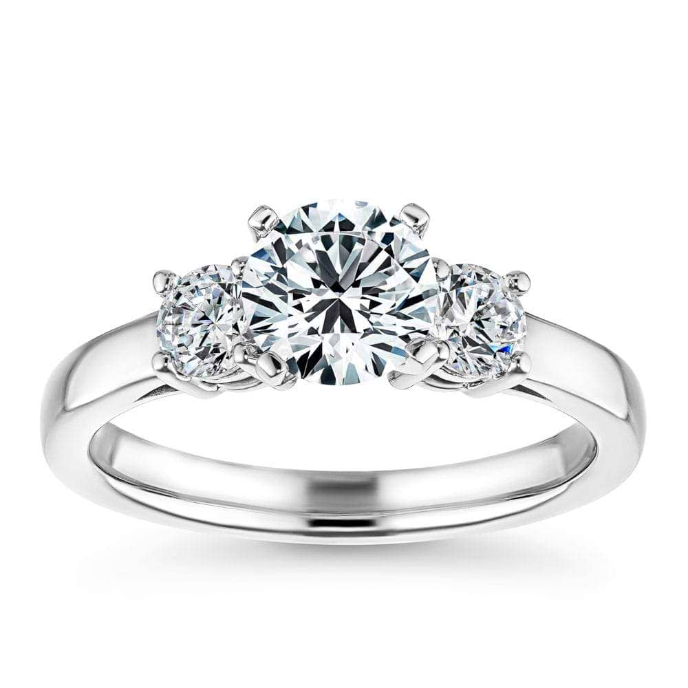 Shown In 14K White Gold With A Round Cut Center Stone|three stone lab grown diamond ring with round cut side stones and a round cut lab grown diamond center stone