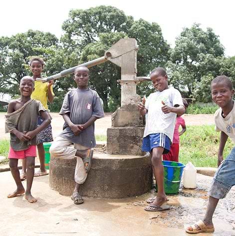 Kids surrounding a free convenient well 