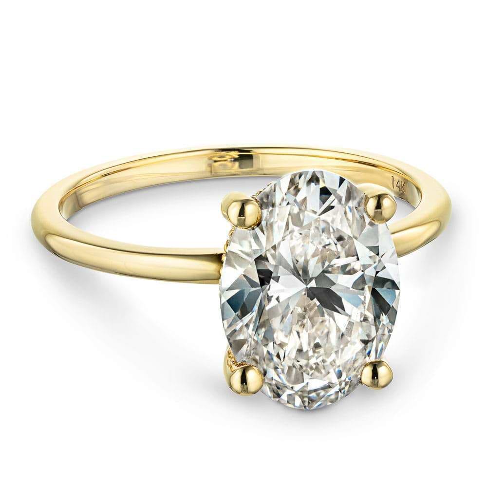 Shown In 14K Yellow Gold With An Oval Cut Center Stone|hidden halo solitaire ring set with an oval cut lab grown diamond center stone