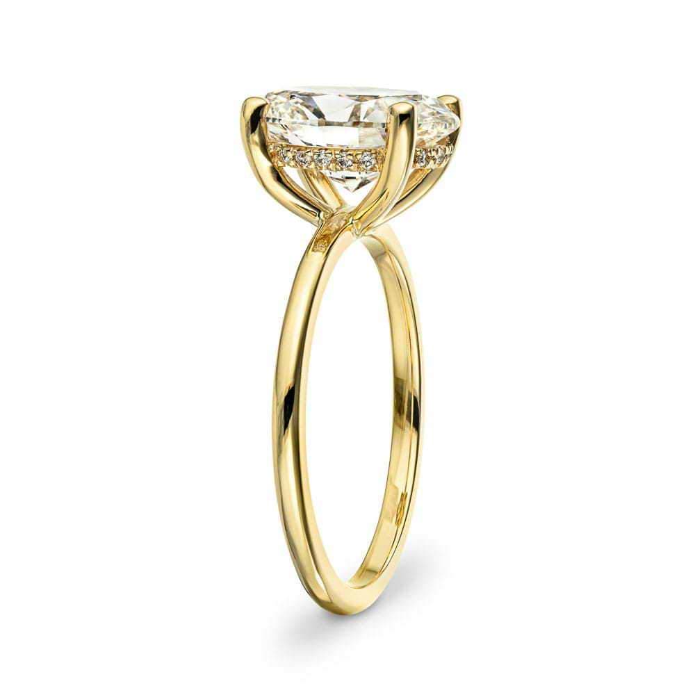Shown In 14K Yellow Gold With An Oval Cut Center Stone