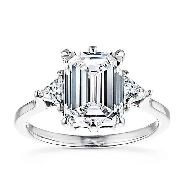 Shown with a 2ct Emerald Cut & Two Triangle Cut Lab Grown Diamonds|Gorgeous conflict free three stone engagement ring with 2ct emerald cut lab grown diamond center stone with triangle side stones set in 14k white gold band