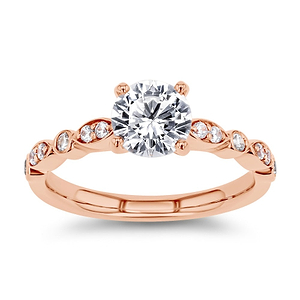 diamond accented engagement ring with round cut lab grown diamond center stone set in 14k rose gold recycled metal