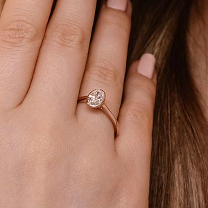bezel solitaire ring with an oval cut lab grown diamond center stone