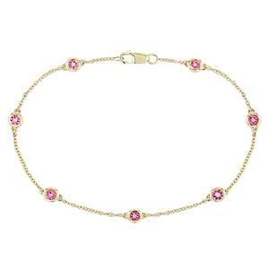 Woman wearing Pink Sapphire Bezel Station Chain Bracelet in 14 carat Yellow Gold from Lab Grown Gemstone specialists MiaDonna 