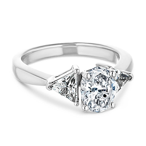 Unique three stone engagement ring with 1ct oval cut lab grown diamond and two 0.50 triangle cut diamond side stones in 14k white gold setting