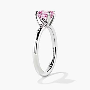 traditional solitaire engagement ring with a cushion cut lab grown pink champagne sapphire gemstone center stone set in 14k white gold recycled metal