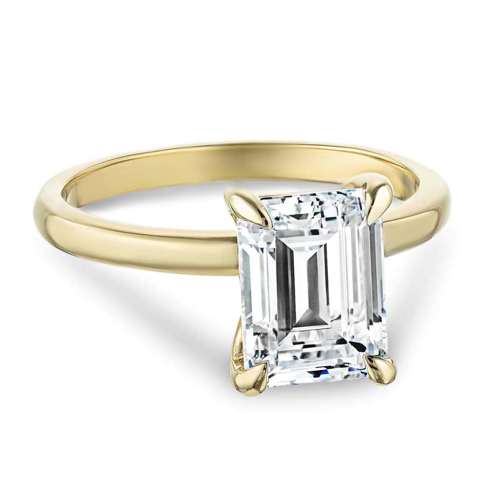 Shown In 14K Yellow Gold with an Emerald Cut Center Stone|traditional claw prong solitaire ring with an emerald cut lab grown diamond center stone