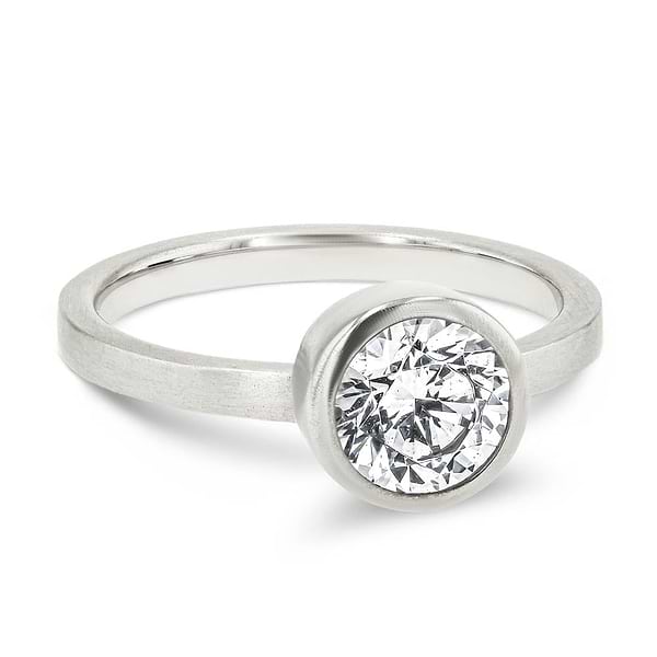 Shown in 14K White Gold with a Satin Finish|bezel set solitaire engagement ring with round cut lab grown diamond in satin finish 14k white gold metal