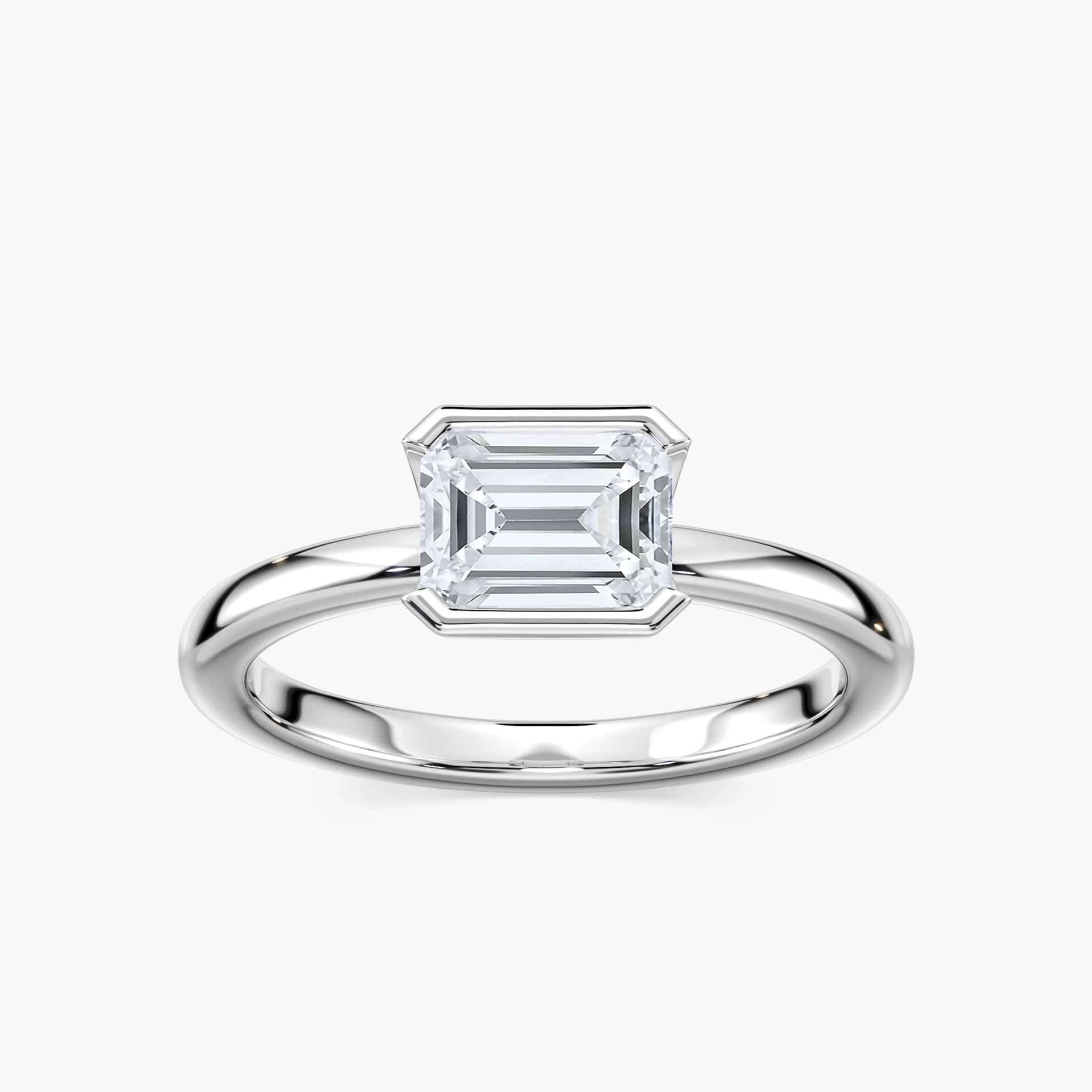 Shown here with a 0.75ct Emerald Cut Lab Grown Diamond center stone in 14K Rose Gold|semi bezel solitaire engagement ring with east to west emerald cut center stone set in 14k rose gold