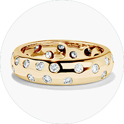 A ring in MiaDonna's "Beverly" style, featuring multiple lab-created diamonds set into the wide yellow gold band in a random pattern, evoking the look of stars in the sky.