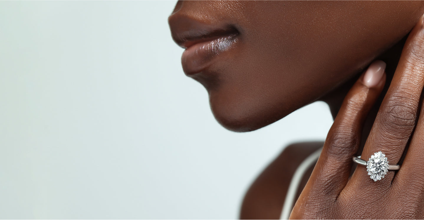 Elegant lady wearing exquisite MiaDonna lab created diamond engagement ring with a fanciful center stone and white gold band.