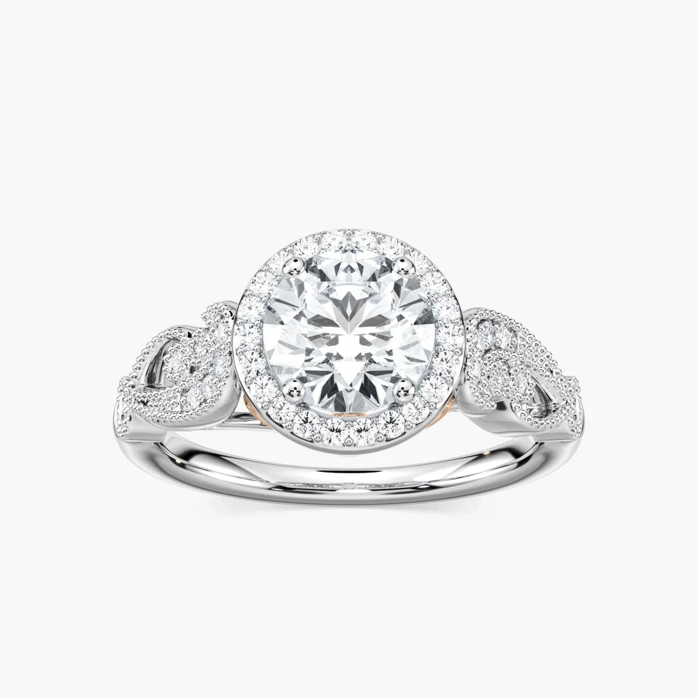 Shown with 1ct Round Cut Lab Grown Diamond in 14k White Gold|Vintage style diamond accented halo engagement ring with 1ct round cut lab created diamond with milgrain and filigree detailing in two tone 14k white gold worn on hand