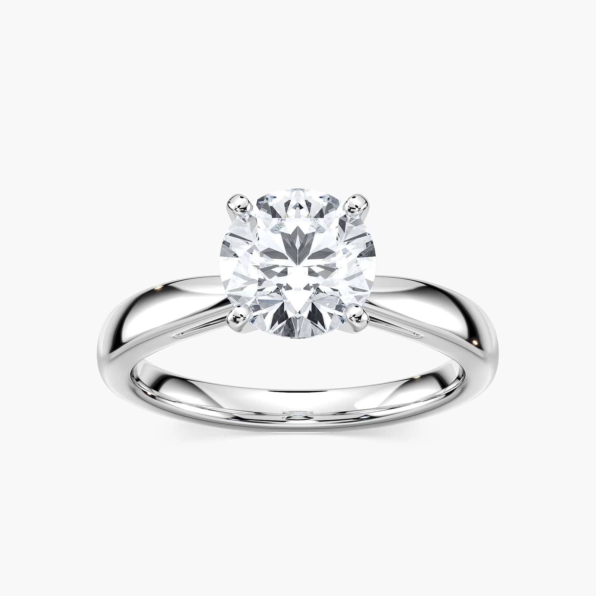 Shown with a 1ct Round Cut Lab Grown Diamond in 14k White Gold|Classic solitaire engagement ring with 1ct round cut lab grown diamond in cathedral style 14k white gold band shown worn on hand