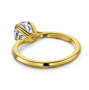 Modern futuristic sci-fi solitaire engagement ring with unique knife edge shank and double prong head holding a 1ct round cut lab created diamond in 14k yellow gold