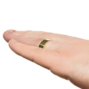 Classic mens wedding band in 6mm 14k yellow gold with high polish finish worn on hand sideview