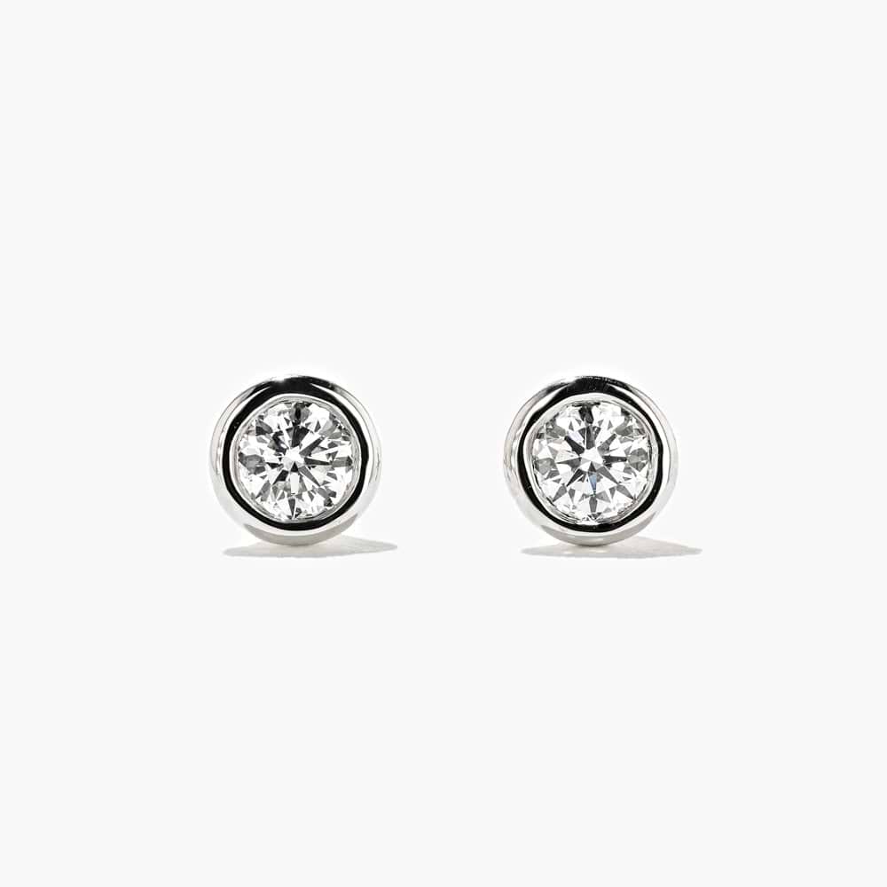 Shown here with 0.50ctw Round lab-grown diamonds in recycled 14K yellow gold. | Lab-grown diamond yellow gold bezel stud earrings.
