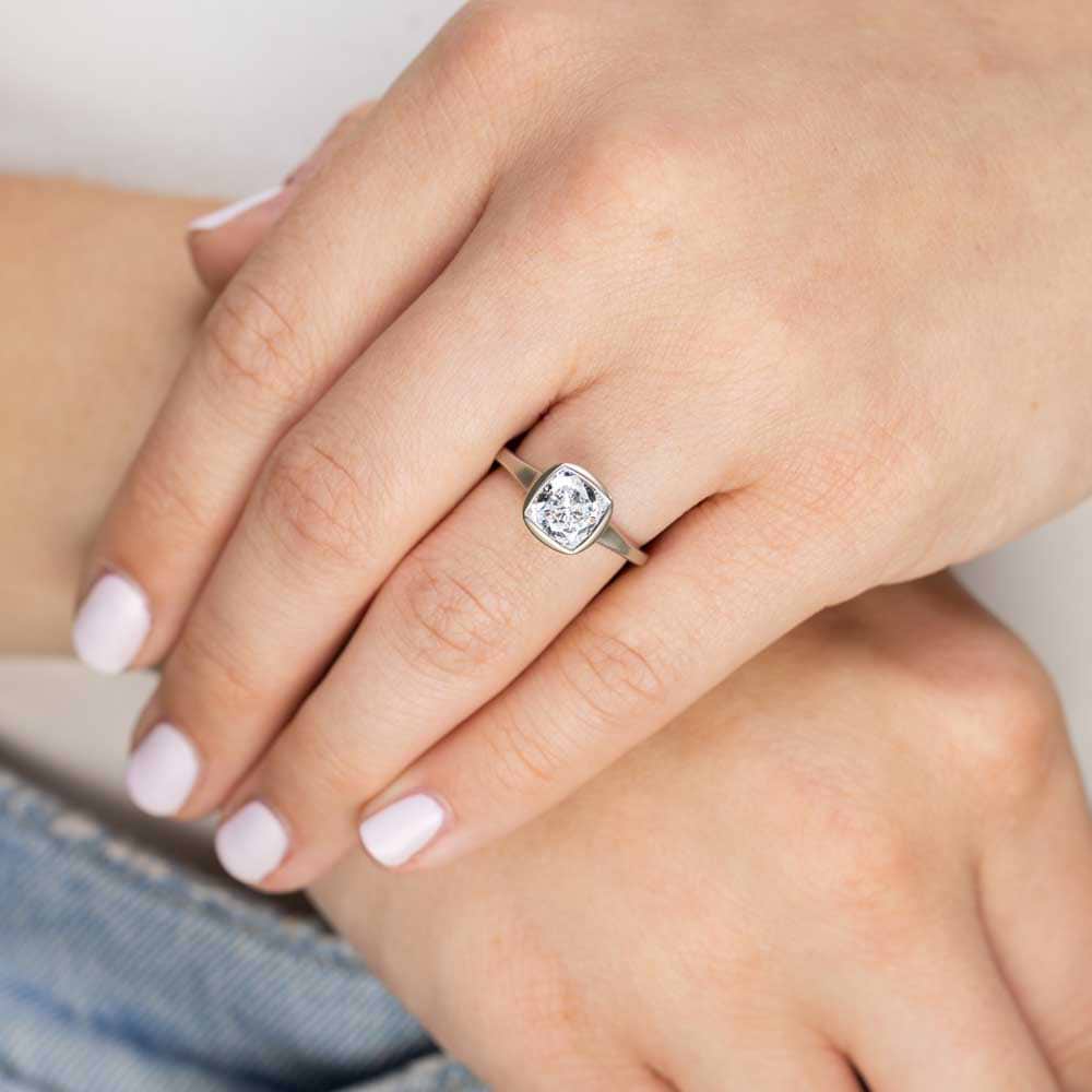 Shown in 14K White Gold with a Satin Finish|bezel set satin finish engagement ring with cushion cut lab grown diamonds