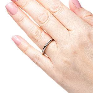 Wedding band with a braided metal design inlay in two tone 14k white gold and rose gold shown worn on hand