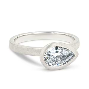 bezel set satin finish engagement ring with pear cut east to west lab grown diamonds