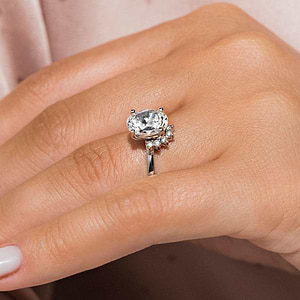 Elegant vintage style half halo engagement ring with 1.5ct oval cut lab grown diamond in 14k white gold shown worn on hand