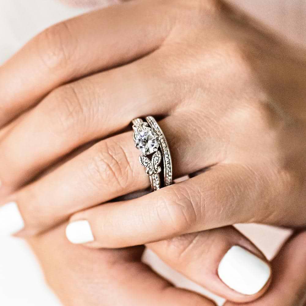 Shown with a 1.0ct Round cut Lab-Grown Diamond with milgrain detail and recycled diamonds in recycled 14K white gold and matching wedding band| antique butterfly milgrain wedding set Shown with a 1.0ct Round cut Lab-Grown Diamond with milgrain detail and recycled diamonds in recycled 14K white gold