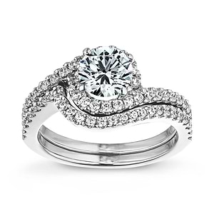 Wavy Diamond accented engagement ring with matching wedding band shown as a set in 14k white gold