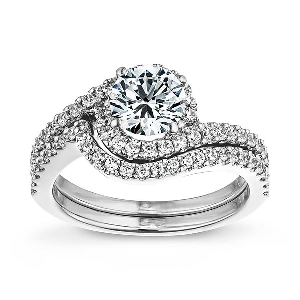 Shown with a 1.0ct Round cut Lab-Grown Diamond with recycled accenting diamond halo and band in recycled 14K white gold with matching band | diamond accented wedding set with 1.0ct round cut lab-grown diamond in recycled 14k white gold