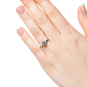 Modern simple minimalistic solitaire engagement ring with 1ct round cut lab grown diamond in 14k white gold shown on hand