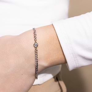 Woman wearing Diamond Bezel Curb Chain Bracelet in 14 carat white gold with one Lab Grown Diamond from MiaDonna