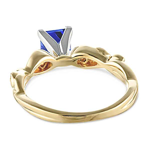 Nature inspired design engagement ring with diamond accented band and a 1ct princess cut lab created blue sapphire in 14k yellow gold shown from back
