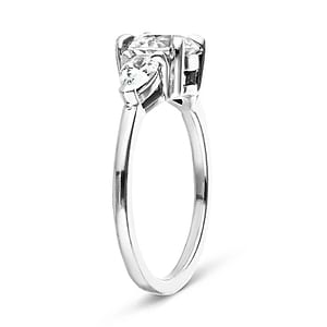 Three stone engagement ring with 1ct round cut lab grown diamond center and 0.5ct pear cut diamond side stones in 14k white gold shown on side