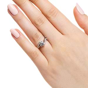 Modern diamond accented engagement ring with twisted band set with 1ct round cut lab grown diamond in 14k white gold shown worn on hand
