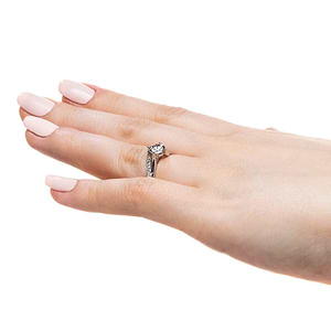 Modern diamond accented engagement ring with twisted band set with 1ct round cut lab grown diamond in 14k white gold worn on hand sideview