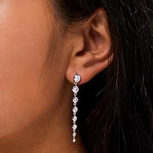 Beautiful graduated bezel drop earrings set with round lab grown diamonds in 14k white gold shown worn on ear